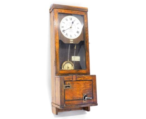 A Gledhill-Brook time recorder, the white painted dial with Arabic numerals in oak case with lockable lower section, keys etc