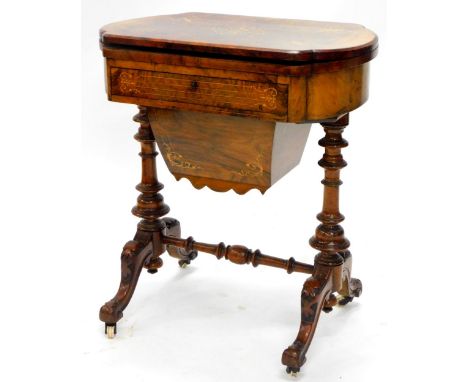 A Victorian burr walnut games/ work table, the hinged shaped top with a moulded edge, enclosing a back gammon, cribbage, and 