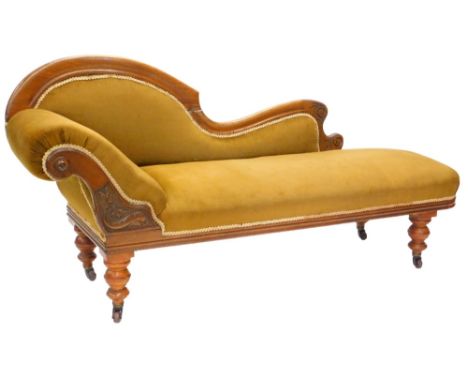 A late 19thC mahogany chaise longue, with a show frame, upholstered in brown draylon on turned tapering legs with ceramic cas