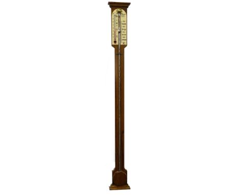 A.Comitti and Son, London. An oak stick barometer in 18thC style with ivorine register, flat turned cistern cover, etc., 94cm