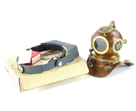 A brass and copper model of a vintage divers helmet, 22cm high, and a jewellers Opti Visor, in original box with some instruc
