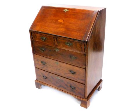 An Edwardian mahogany and boxwood strung bureau, the fall inlaid with a central marquetry fan, enclosing a fitted interior ab