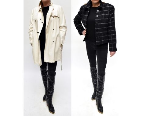 BURBERRY; a short cream unlined trench coat, with pop stud double breasted fastening, belt, two zip front pockets and iconic 