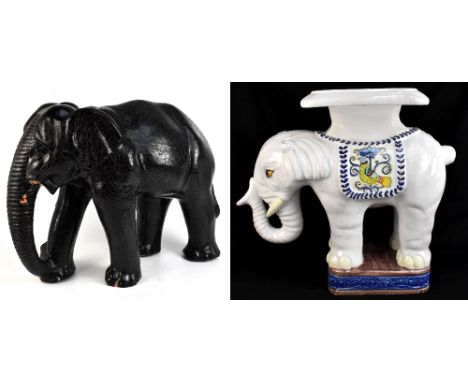A large modern decorative bronzed model elephant (tusks now loose), height 54cm, length 75cm, and a similar sized ceramic exa