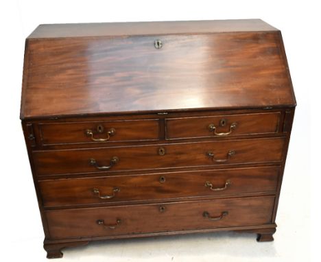 A Georgian mahogany bureau, the fall-front enclosing fitted interior above two short and three long drawers on bracket feet, 