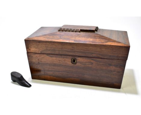 A Victorian rosewood sarcophagus tea caddy, the hinged cover enclosing a matched pressed glass mixing bowl and two compartmen