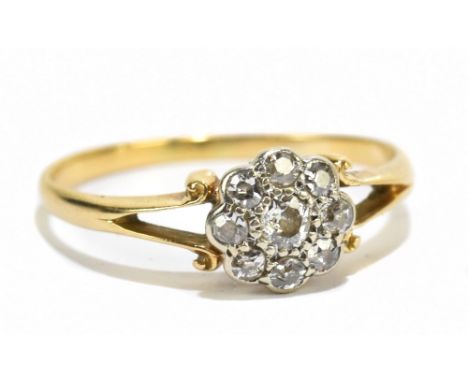 A yellow metal small diamond cluster ring, the central stone approx 0.10ct, flanked by eight further diamonds, approx size M/