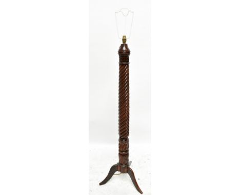 An early 20th century mahogany bed post standard lamp with wrythen turned column, raised on swept supports, height 130cm.Addi