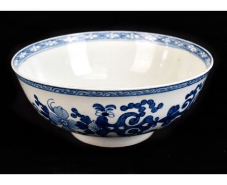 ATTRIBUTED TO LIVERPOOL; an 18th century English porcelain footed bowl with underglaze blue and floral decoration beneath sty