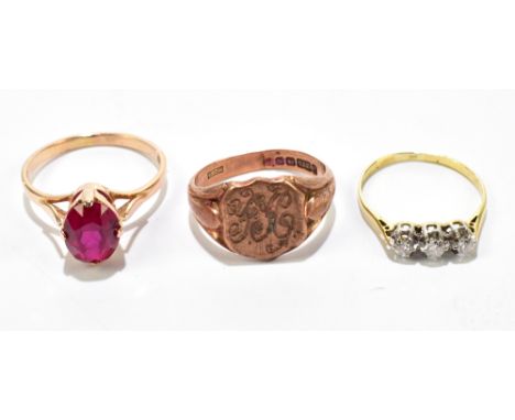 A 9ct rose gold signet ring with engraved initials, size R, approx 5.9g, a yellow metal three stone diamond ring, size Q, app