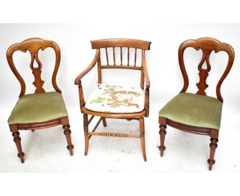 A pair of 19th century mahogany framed camel back dining chairs of serpentine outline with pierced shaped splats and drop in 