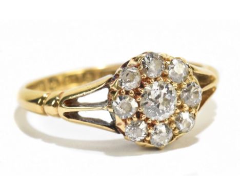 An 18ct yellow gold diamond cluster ring, the centre stone approx 0.25ct flanked by eight further diamonds, approx size M/N, 