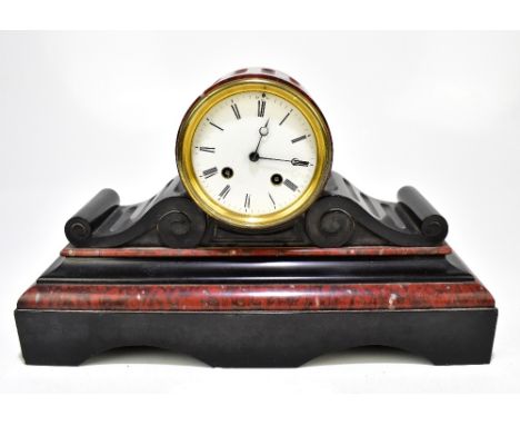 A late 19th century French rouge marble and black slate mantel clock, the white enamelled dial set with Roman numerals housin