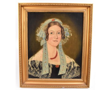 19TH CENTURY ENGLISH SCHOOL; oil on relined canvas, portrait of a lady wearing light&nbsp; blue silk and lace bonnet, coral n