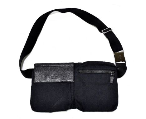 GUCCI; a cloth and black leather monogram 'GG' canvas belt/waist bag, serial no.1011530, with silver tone hardware, a large z