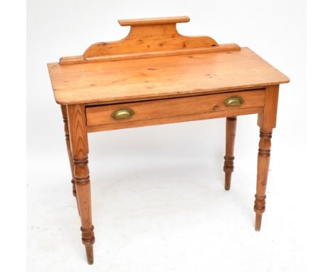 A pine hall table with raised shaped back above single long drawer on turned supports to peg feet, height 90.5cm, width 90cm,