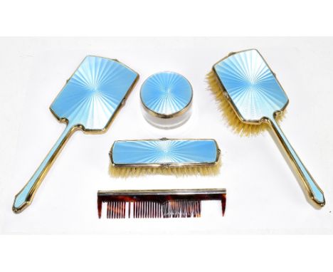 ALBERT CARTER; a hallmarked silver five piece dressing table set with blue guilloche enamel sunburst decoration, Birmingham 1