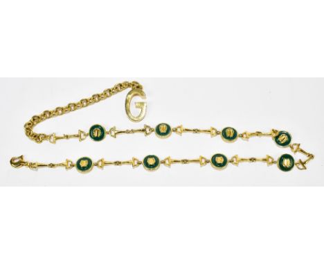 GUCCI; a gold tone horsebit chain link adjustable waist belt, with interlocking Gucci horseshoe, green enamel charms with lob