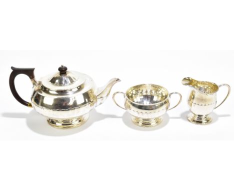 JAMES DEAKIN &amp; SONS; a George V hallmarked silver three piece tea service, with panelled decoration, Sheffield 1928, appr
