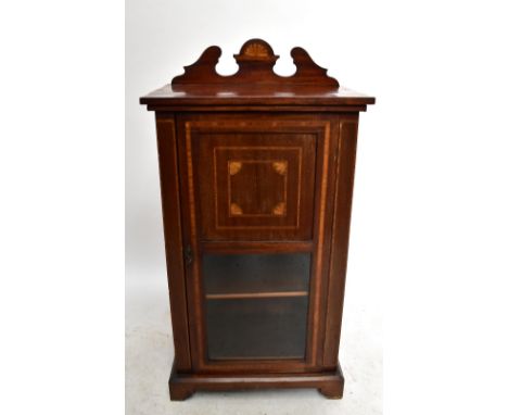 An Edwardian mahogany and inlaid side cabinet, the part glazed door enclosing three shelves, on bracket feet, height 117, wid