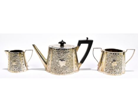 JONES & STEPHENSON; a Victorian hallmarked silver three piece tea service, with repoussé floral detail, length of teapot 25cm