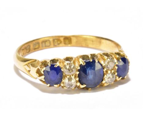 An Edward VII 18ct yellow gold sapphire and diamond ring set with three sapphires and four tiny diamonds, Chester 1905, size 