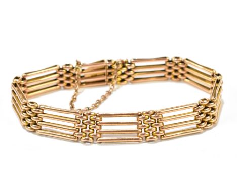 A 15ct yellow gold gate link bracelet with sprung clasp and safety chain, length approx 18.5cm, width approx 1cm, approx 20.2