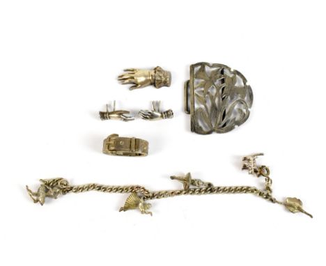 Three late 19th/early 20th century silver brooches/pins modelled as hands, a scarf clip modelled as a belt and buckle, a daff