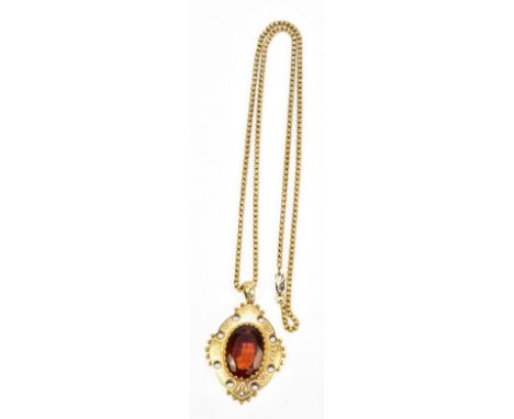 A Victorian yellow metal white enamelled and coloured stone set lozenge shaped pendant suspended on a ball link chain with 14