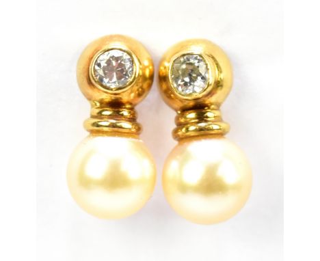 A pair of yellow metal diamond and pearl earrings, each with collet set diamond to the upper section and above a pearl drop, 