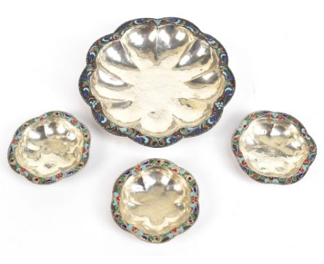 Four sterling silver dishes each with enamel floral detail to the scalloped edge, diameter of largest example 15cm, approx we