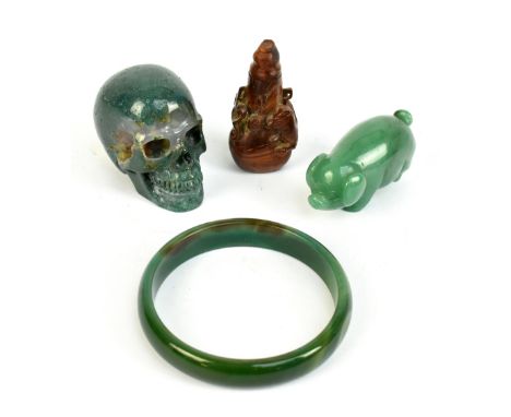 Three pieces of hardstone to include a carved skull, a bangle, also a wooden carved snuff bottle (4).Additional InformationTh