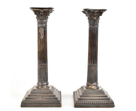 WILLIAM HUTTON &amp; SONS; a pair of George V hallmarked silver Corinthian column candlesticks with detachable sconces, Sheff