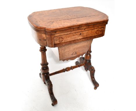 A Victorian walnut sewing/games table with marquetry detail to swivel top, the hinged lid with inlaid chess and backgammon bo