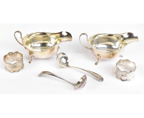 VINER'S LTD; a pair of George V hallmarked silver sauce boats, each raised on pad feet, complete with matching sauce ladles, 