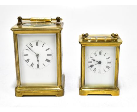 Two brass cased carriage clocks, both circular dials set with Roman numerals, the smaller with back plate stamped 'A.C.C.', t