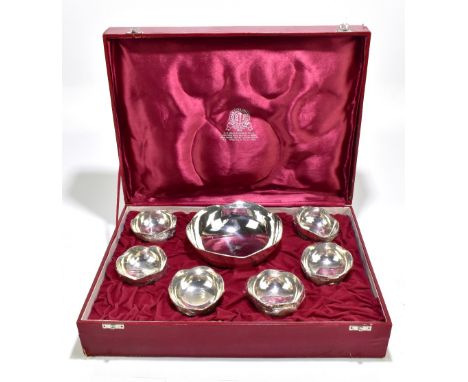 A boxed Indian white metal seven piece service comprising large bowl and six smaller bowls, each with cast beaded rims, retai