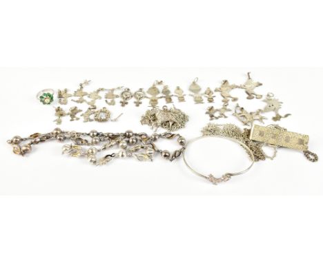 A group of silver and white metal charms and bracelets, also a bangle, various cartoon character charms and a ring, total app