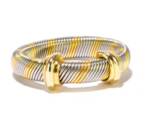 CARTIER; a yellow and white metal ring of twisted two tone design, signed and numbered 982706-50, size J, approx 5.6g.Additio