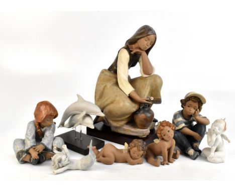 LLADRO; a large salt glazed figure, young woman holding rose kneeling beside water jug, height 35.5cm, with base, four furthe