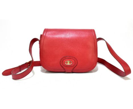 CELINE; a soft nappa leather D-shaped shoulder bag with front flap and gold tone logo, adjustable strap, and cream nappa leat