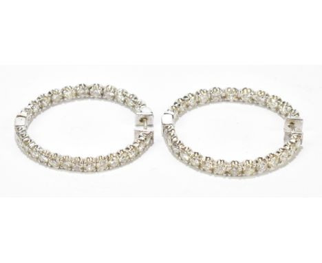 A pair of 14ct white gold diamond set large hoop earrings with diamonds set to both the front panel and inside rear panel and