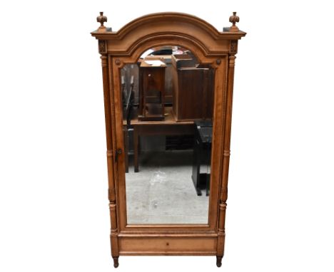 A 19th century French satin walnut wardrobe with carved detail to the corners and moulded cornice, above central door with mi