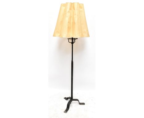 A wrought iron standard lamp on three outswept supports,&nbsp;height&nbsp;excluding fitment 150cm.Additional InformationElect