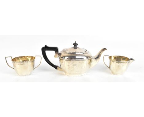 KIRWAN &amp; CO LTD; a George V hallmarked silver three piece tea service, with panelled decoration, Birmingham 1933, approx 