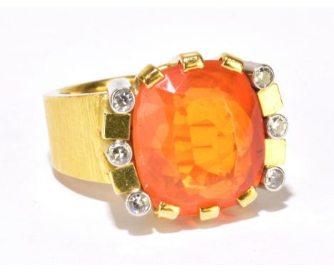 A large 18ct textured yellow gold diamond set dress ring with central large orange coloured stone surrounded by six collett s