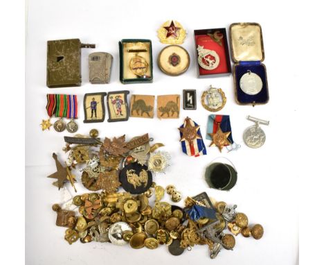 A collection of mixed militaria including a World War I era gun fashioned from a door lock, mixed cap badges, buttons and pin