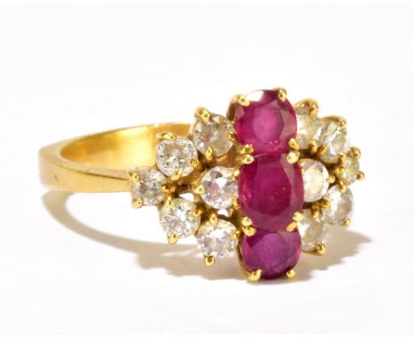 An 18ct yellow gold diamond and ruby stepped cluster ring, centered with three stepped rubies above twelve brilliant cut diam