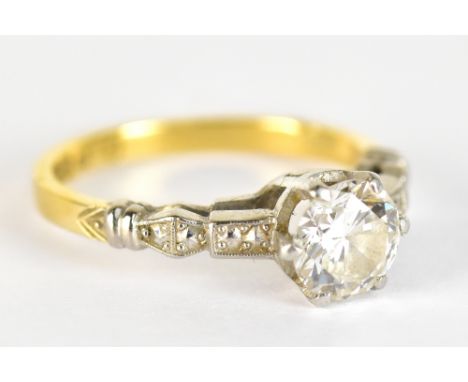 An 18ct yellow gold and platinum diamond solitare ring, the round brilliant cut stone weighing approx 1.0ct, size K, approx 2