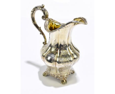A William IV hallmarked silver cream jug with chased decoration to the panelled body, with gilded interior, Newcastle 1841, h